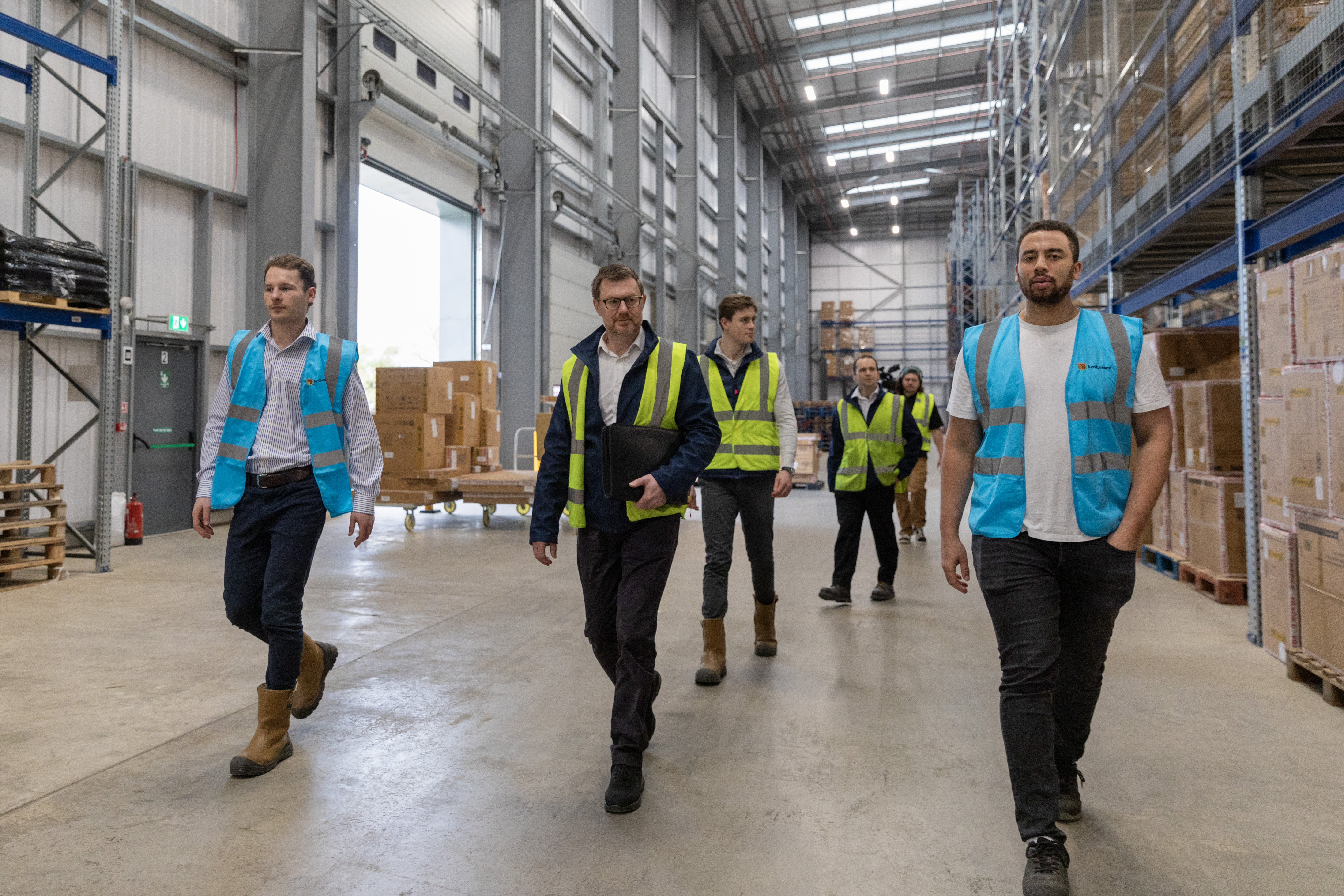 Co-Founders Monty George and Dan Beckles (in blue) showcasing their warehouse 